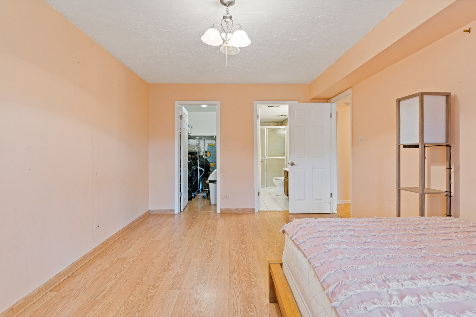 11130 NW Road, Unit E Palos Hills, IL 60465 - Photo 20 of 26 a bedroom with a bed and a chandelier