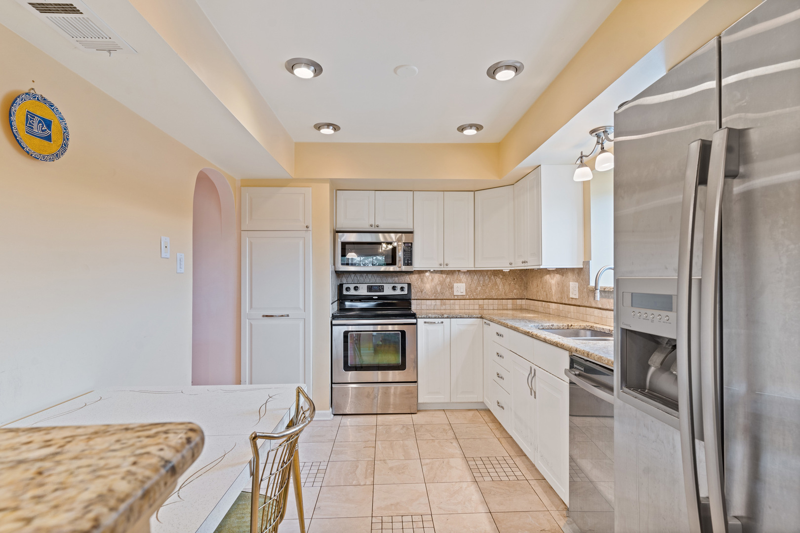 11130 NW Road, Unit E Palos Hills, IL 60465 - Photo 5 of 26 a kitchen with stainless steel appliances granite countertop a refrigerator and a stove top oven