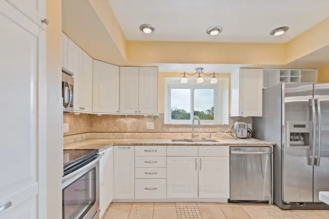a kitchen with a sink stove and refrigerator