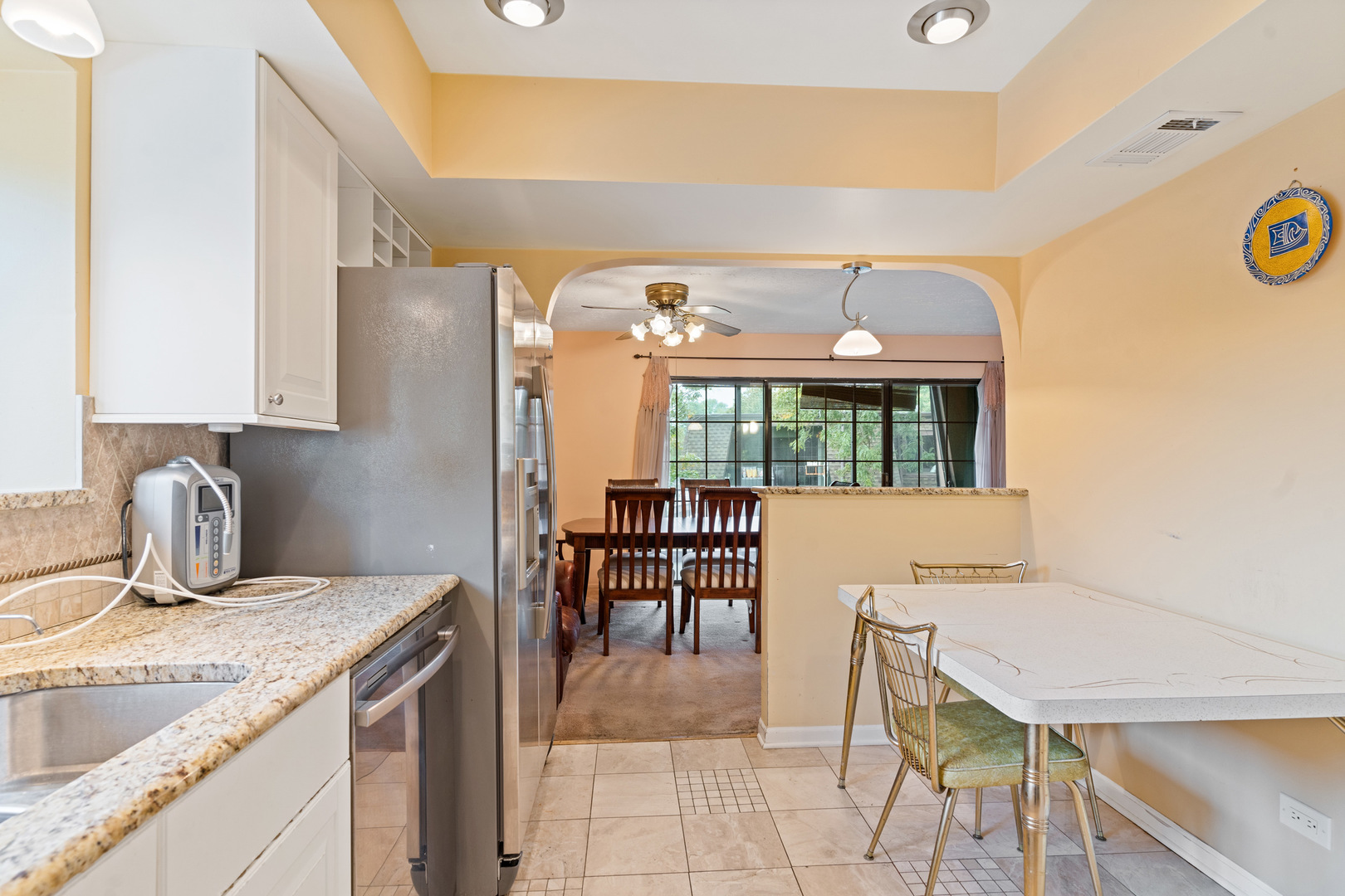 11130 NW Road, Unit E Palos Hills, IL 60465 - Photo 8 of 26 a kitchen with a table chairs and a refrigerator