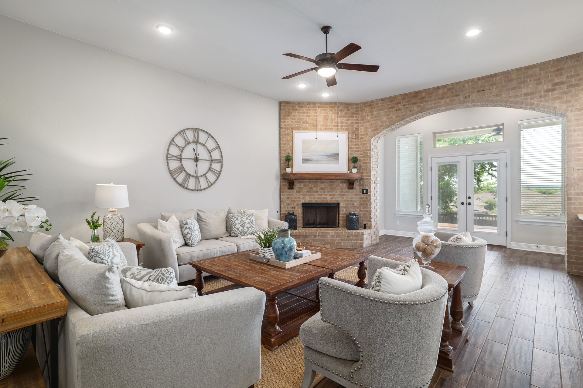 309 Rancho Sienna Loop Georgetown, TX 78628 - Photo 14 of 40 Spacious living area featuring a brick fireplace with a wood mantel, wood-finish flooring, and recessed lighting