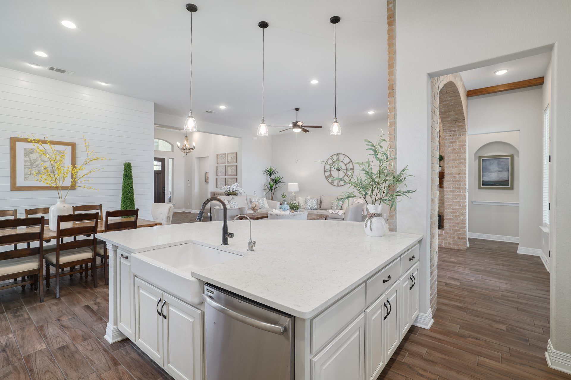 309 Rancho Sienna Loop Georgetown, TX 78628 - Photo 18 of 40 Kitchen island featuring a farmhouse sink, stainless steel dishwasher, and light-toned countertop