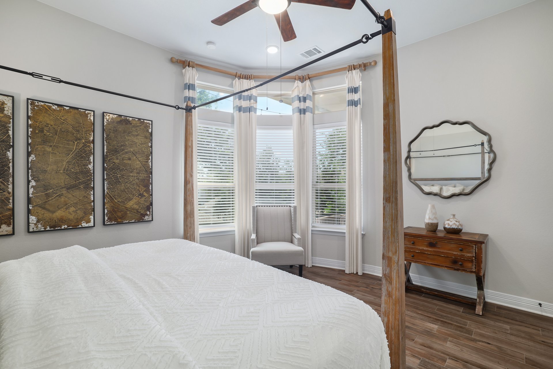 309 Rancho Sienna Loop Georgetown, TX 78628 - Photo 21 of 40 Wood-finish flooring enhances this room featuring a bay window with blinds and drapes
