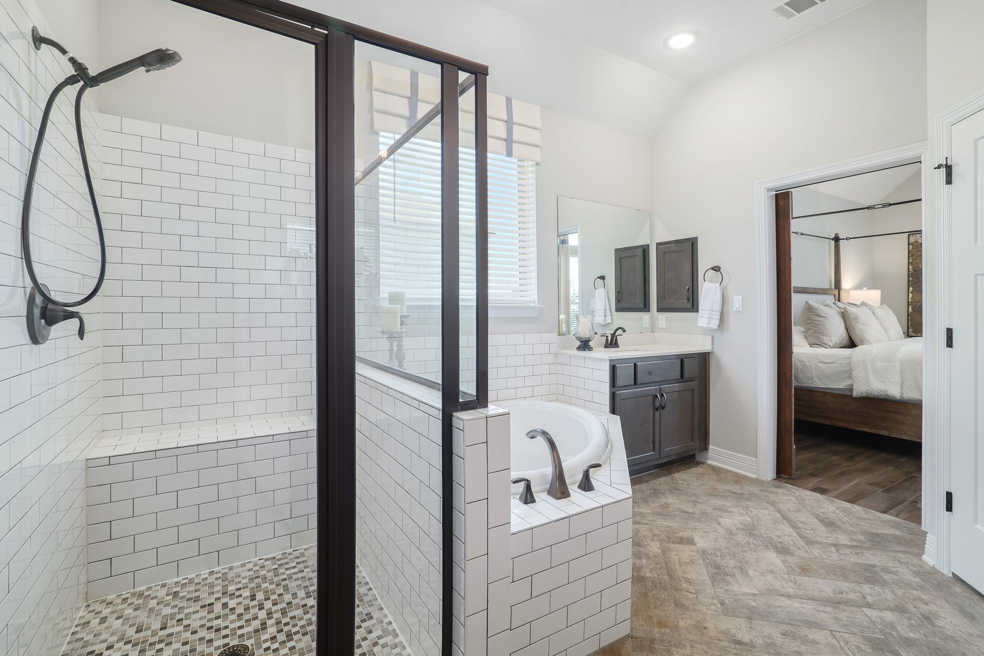 309 Rancho Sienna Loop Georgetown, TX 78628 - Photo 24 of 40 Enclosed shower with subway tile surround, integrated bench, and mosaic tile flooring