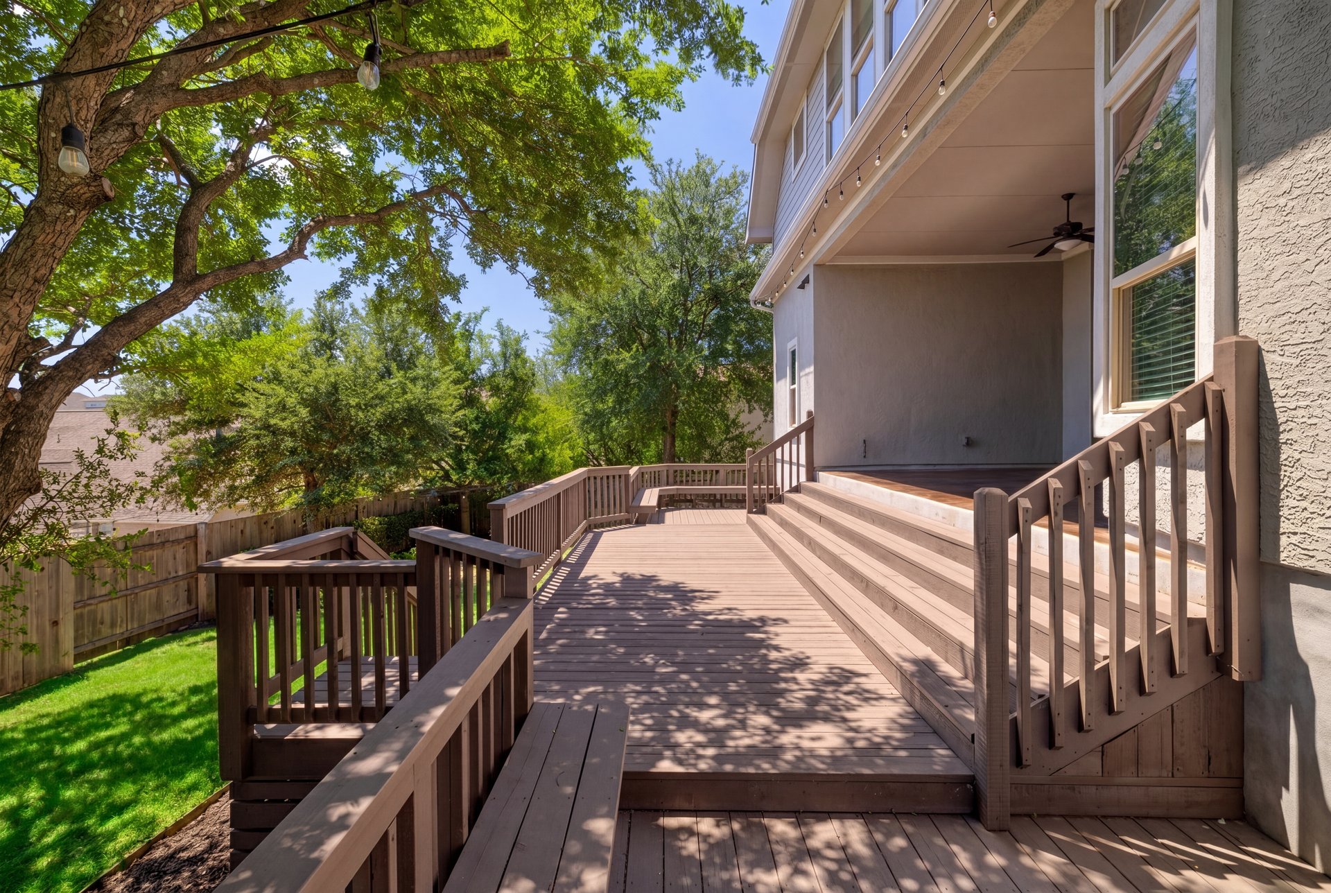 309 Rancho Sienna Loop Georgetown, TX 78628 - Photo 36 of 40 Expansive wood-finish multi-level deck with integrated steps, sturdy wood railings, and a covered patio area with a ceiling fan