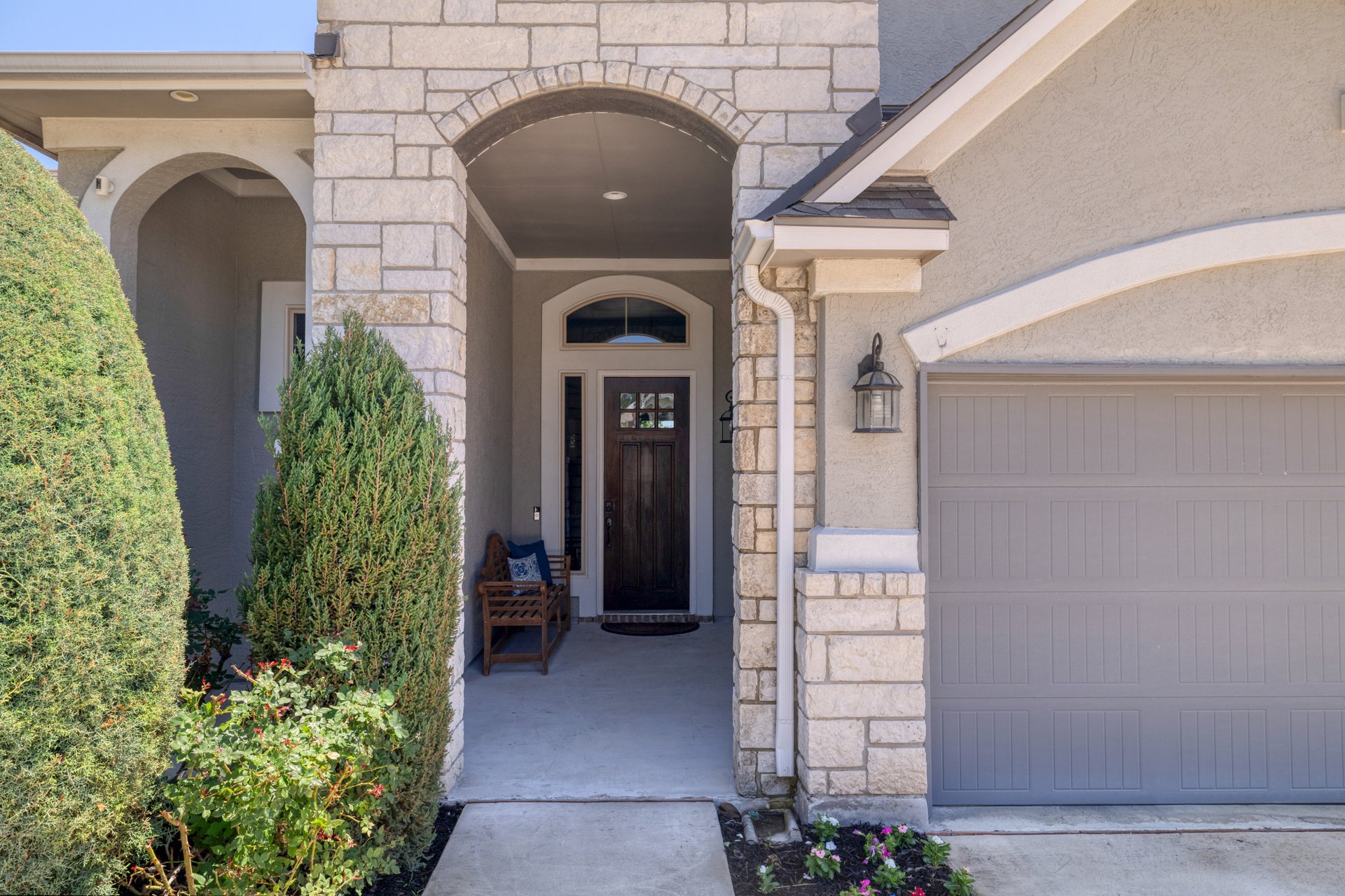 309 Rancho Sienna Loop Georgetown, TX 78628 - Photo 5 of 40 Stone veneer facade with an arched entryway