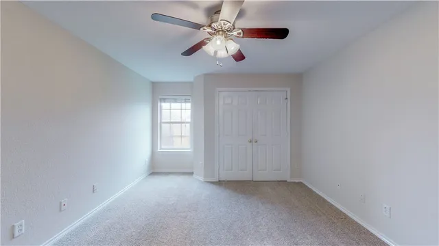 a view of room with window and ceiling fan