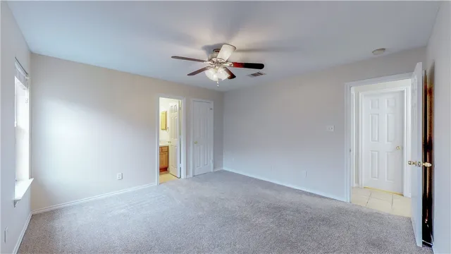 a view of an empty room with a ceiling fan