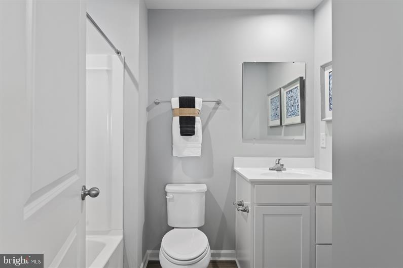 4704 Cooks Point Court, Unit 5 Lanham, MD 20706 - Photo 17 of 17 a bathroom with a toilet sink and mirror