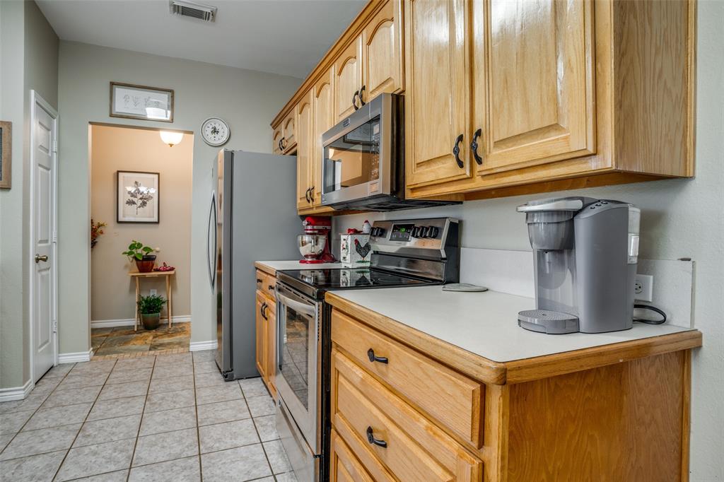 144 Red Road Howe, TX 75459 - Photo 11 of 27 a kitchen with stainless steel appliances granite countertop a refrigerator and a stove