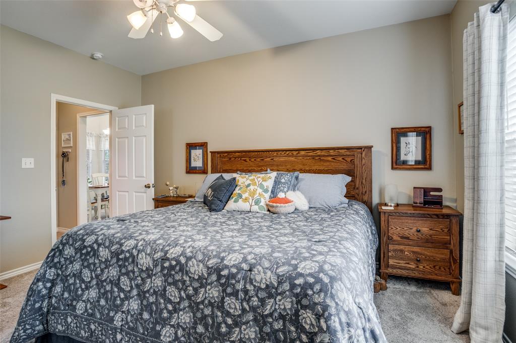 144 Red Road Howe, TX 75459 - Photo 23 of 27 a bedroom with a bed and a chandelier