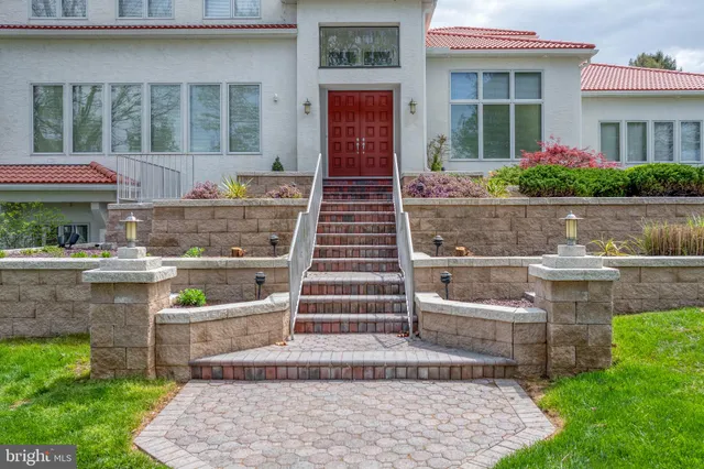 a dining room with furniture a fireplace and a large window