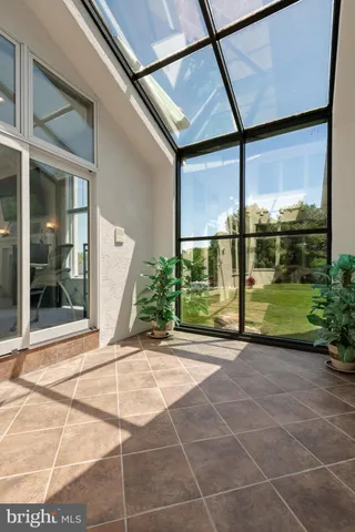 a living room with furniture a fireplace and a floor to ceiling window
