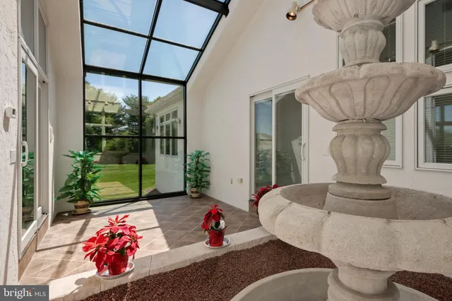 a view of a workspace with bookshelf and a workspace