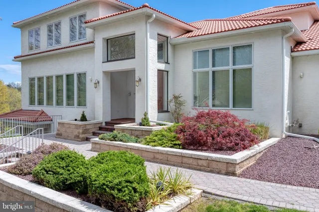 a kitchen with stainless steel appliances granite countertop a refrigerator a sink a stove a dining table and chairs