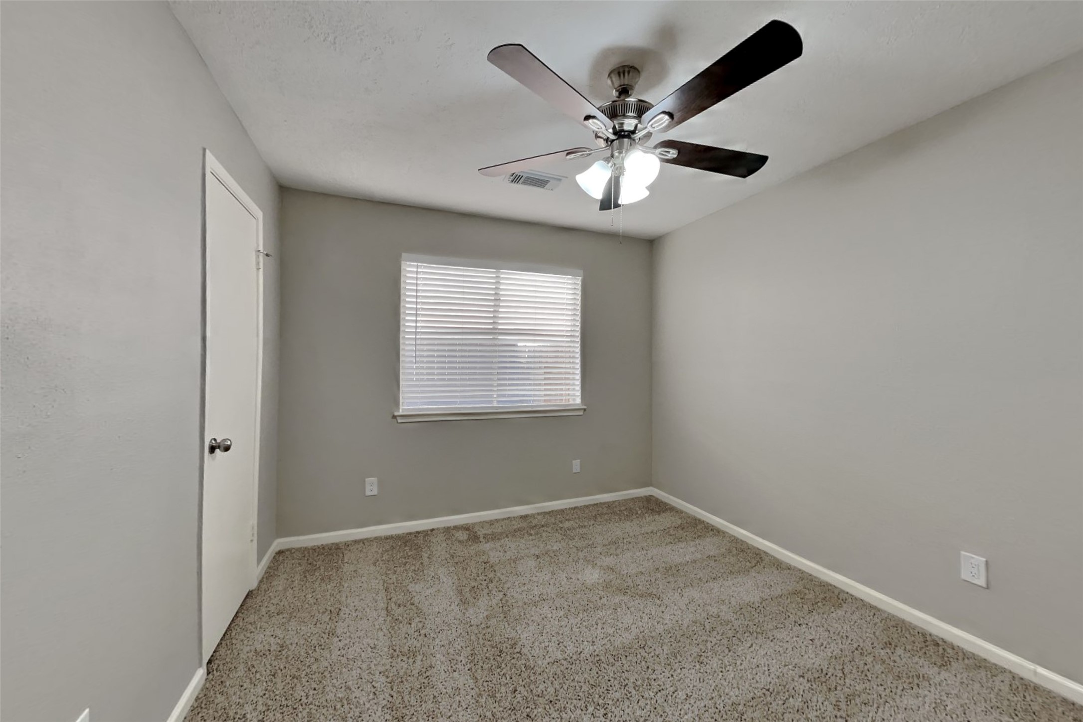 2217 Clemson Drive Katy, TX 77493 - Photo 12 of 18 an empty room with a window and a fan