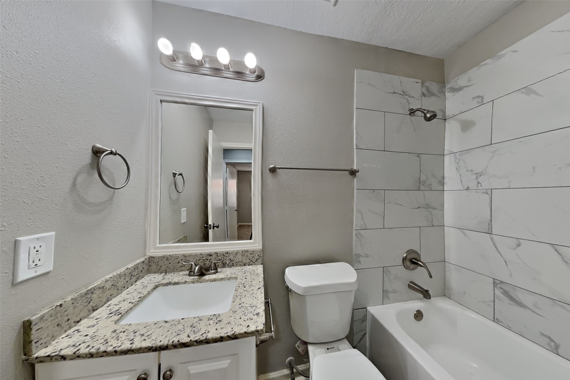 2217 Clemson Drive Katy, TX 77493 - Photo 15 of 18 a bathroom with a granite countertop sink a toilet and bathtub