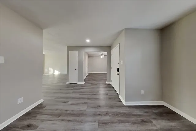 a view of a hallway with wooden floor