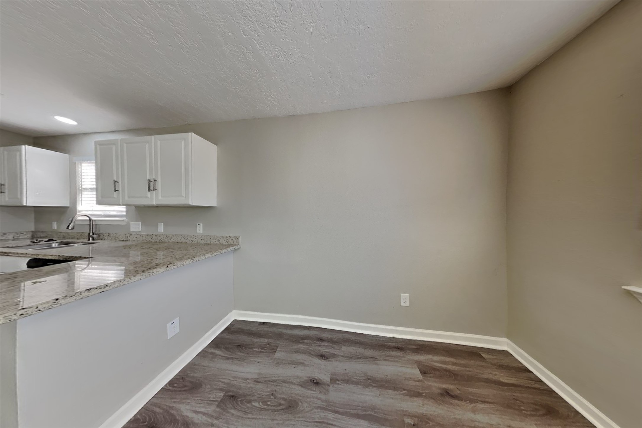 2217 Clemson Drive Katy, TX 77493 - Photo 7 of 18 a view of a kitchen with wooden floor and cabinets