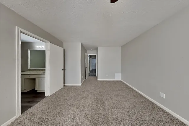 a view of a livingroom and a empty room