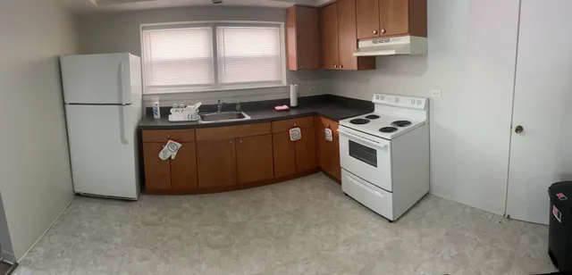 a kitchen with stainless steel appliances granite countertop a stove a refrigerator and a sink