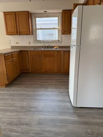 a kitchen with stainless steel appliances granite countertop a refrigerator a sink and dishwasher