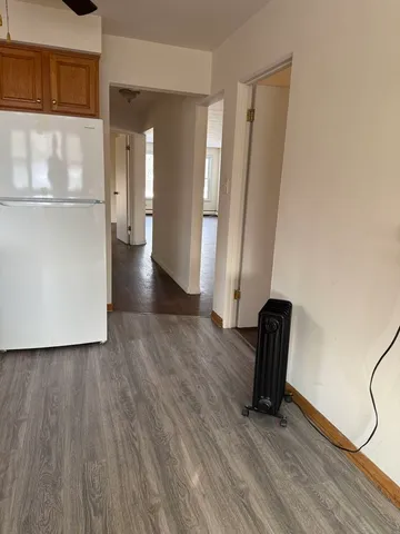 a view of a room with wooden floor and a window