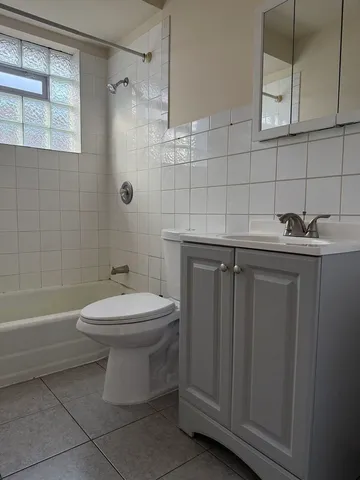 a bathroom with a toilet sink and shower