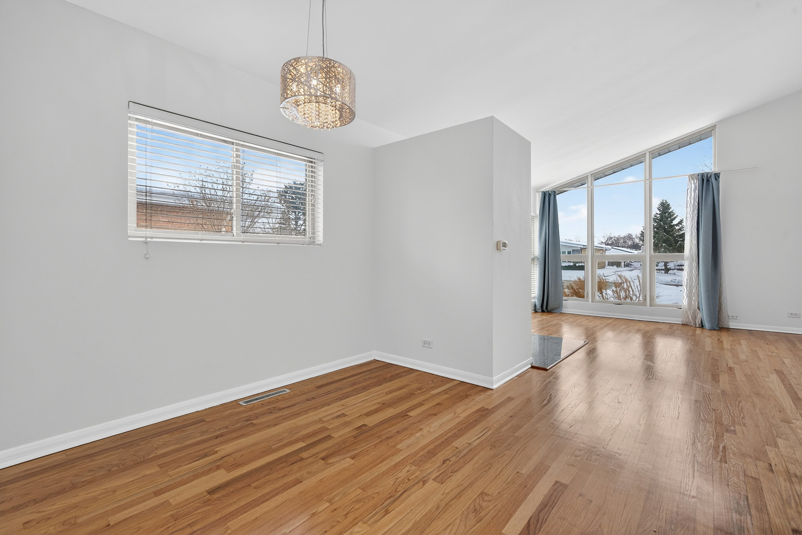 8516 West Normal Avenue Niles, IL 60714 - Photo 11 of 35 a view of an empty room with wooden floor and a window