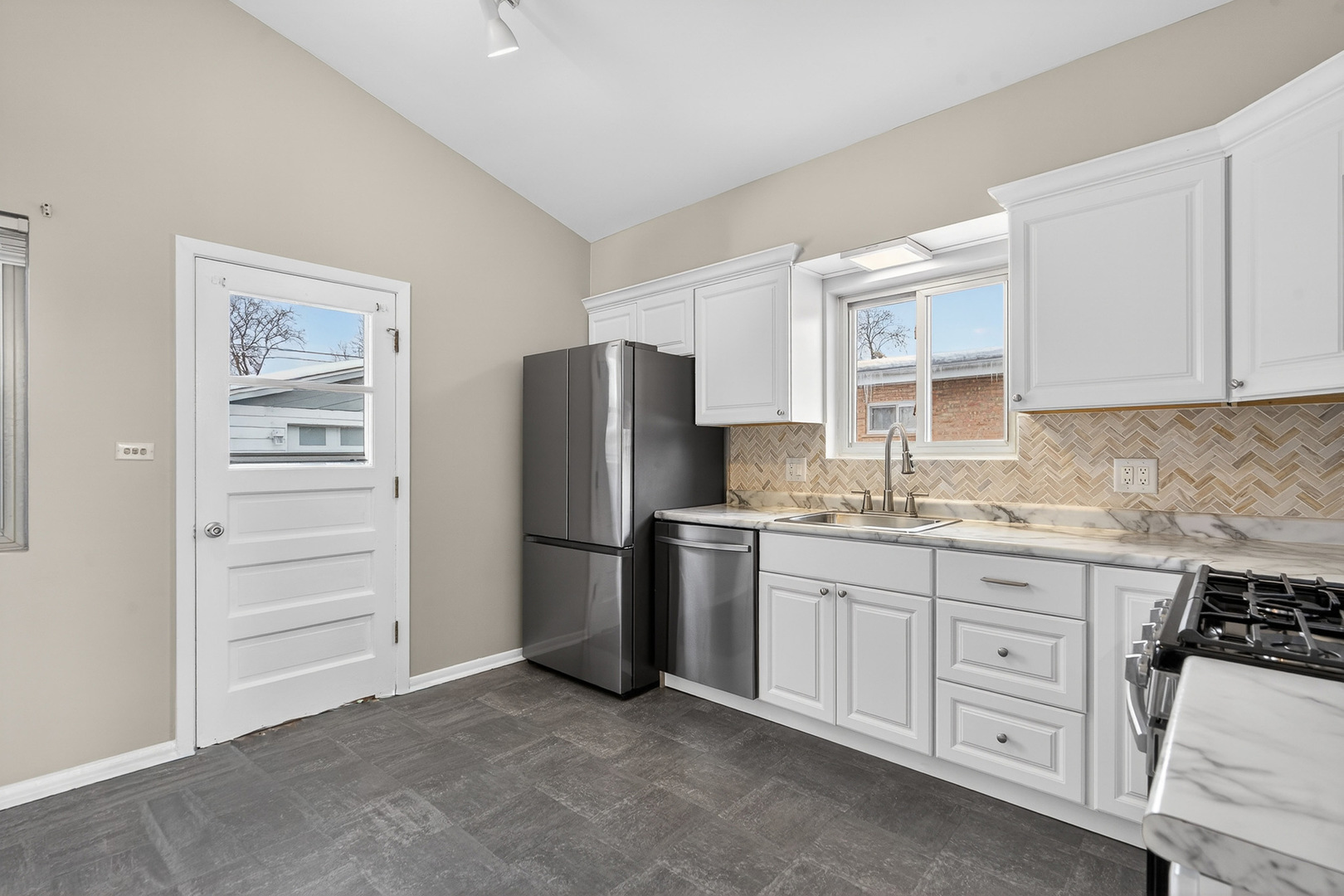 8516 West Normal Avenue Niles, IL 60714 - Photo 14 of 35 a kitchen with granite countertop cabinets and refrigerator