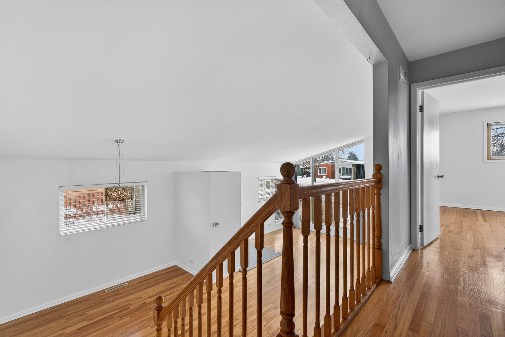 8516 West Normal Avenue Niles, IL 60714 - Photo 16 of 35 a view of a hallway with wooden floor and stairs