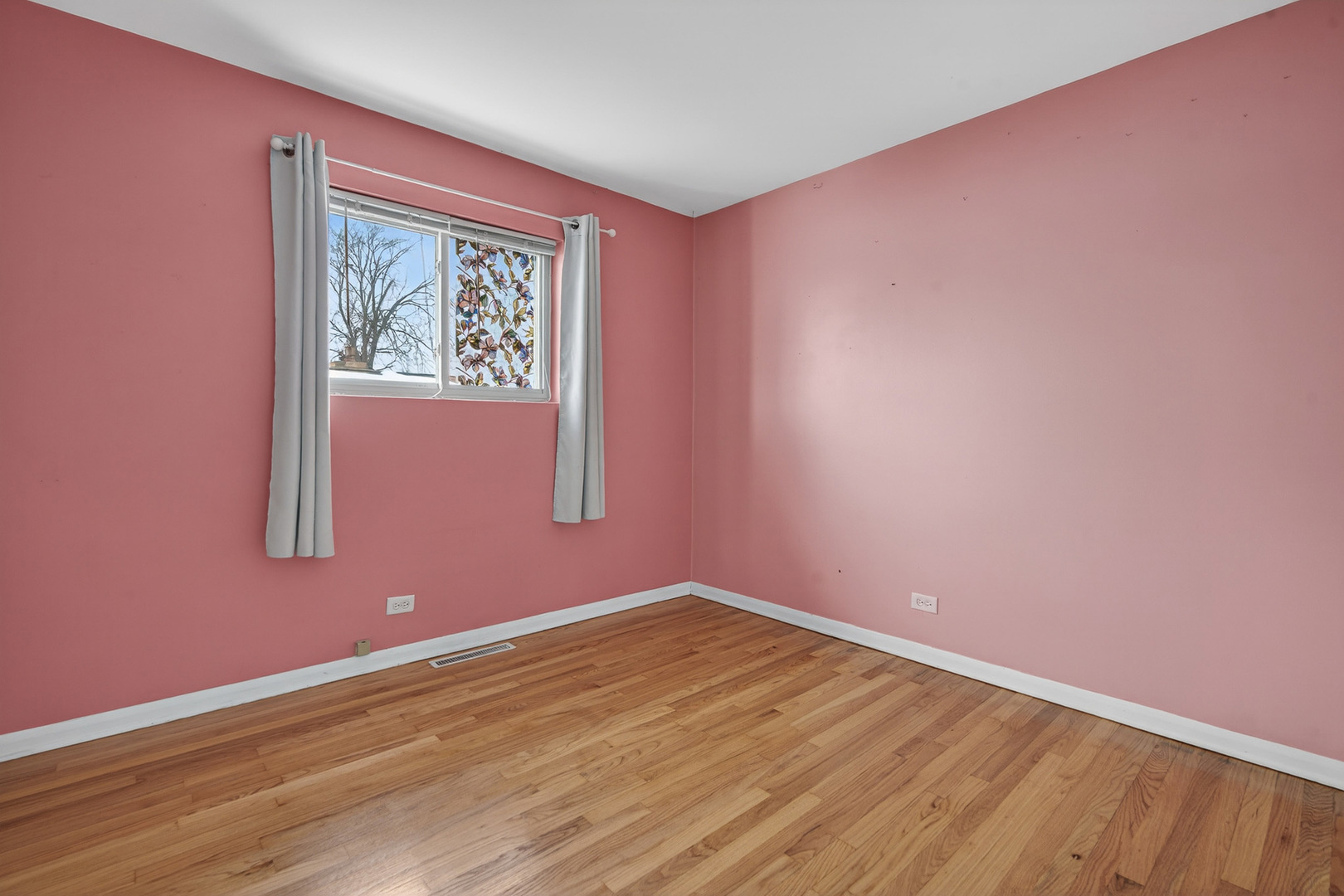 8516 West Normal Avenue Niles, IL 60714 - Photo 19 of 35 a view of an empty room with wooden floor and a window