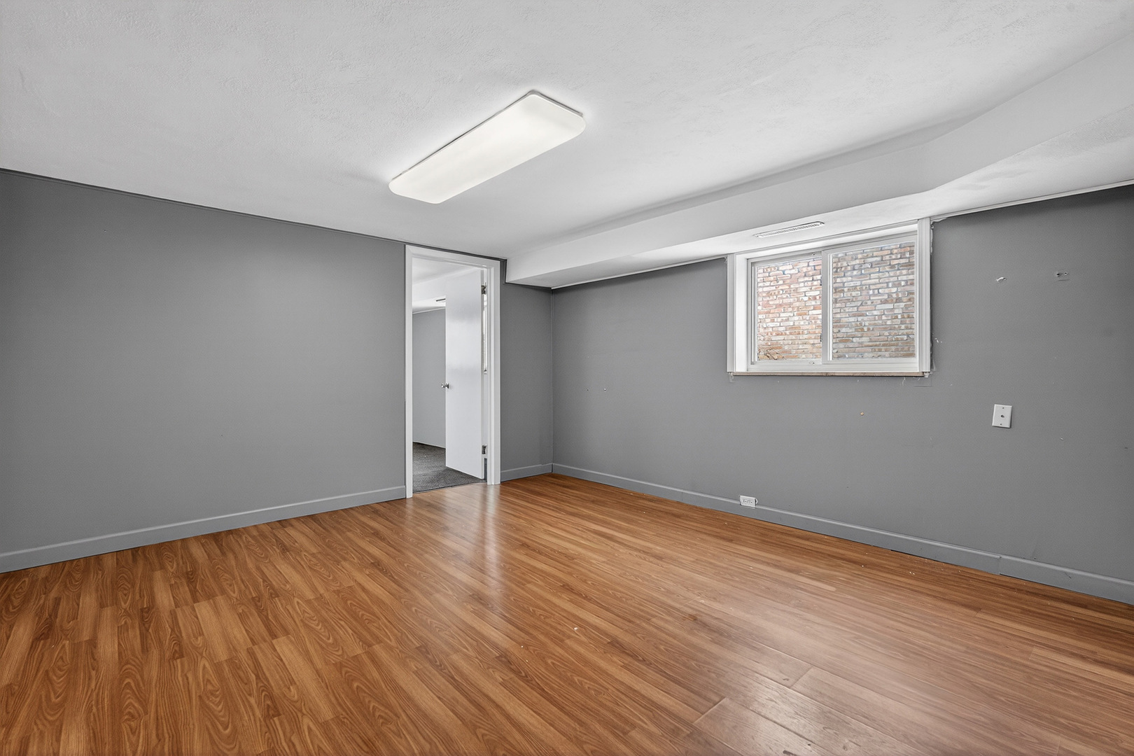 8516 West Normal Avenue Niles, IL 60714 - Photo 23 of 35 a view of an empty room with wooden floor and a window