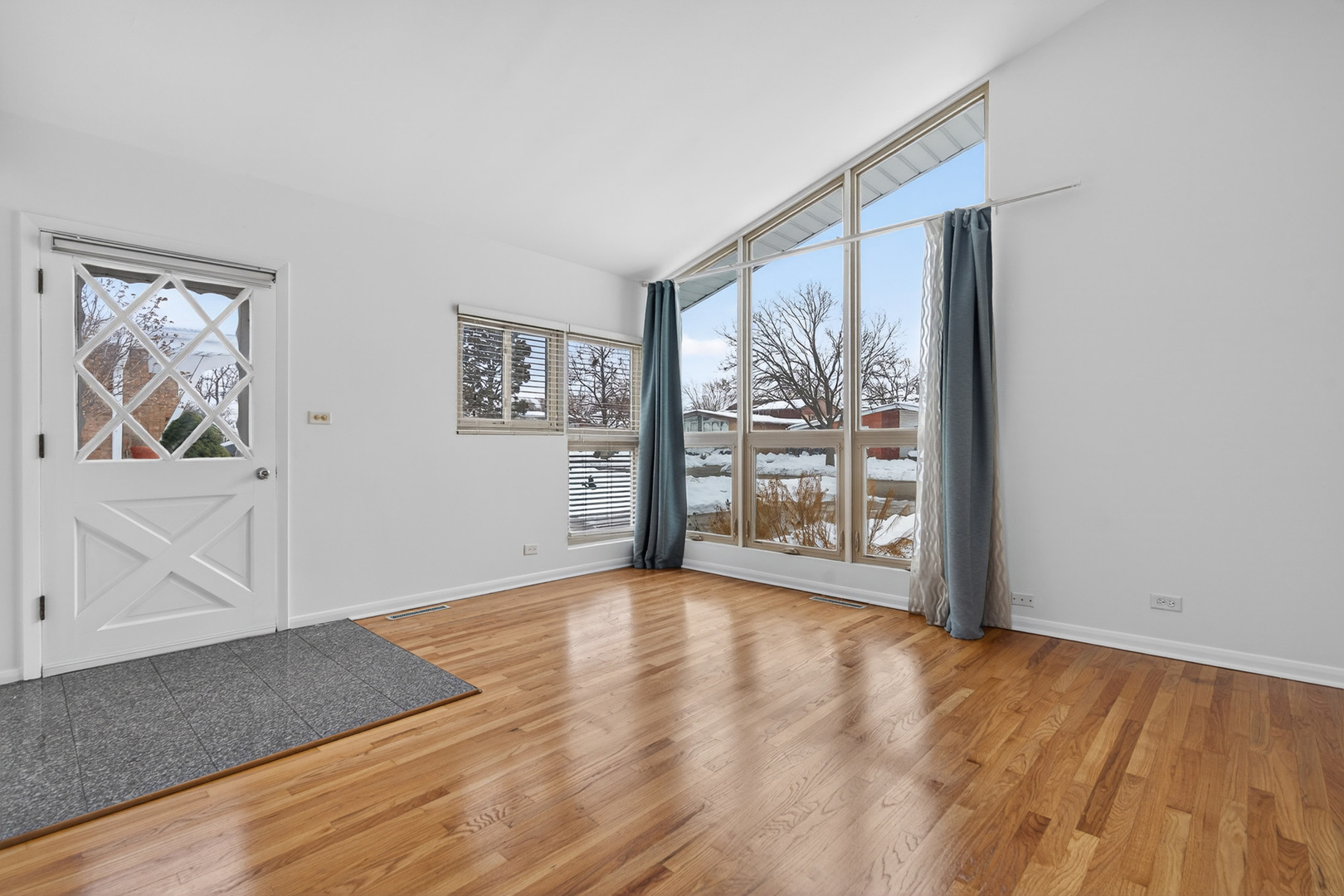 8516 West Normal Avenue Niles, IL 60714 - Photo 5 of 35 a view of an empty room with a window and wooden floor