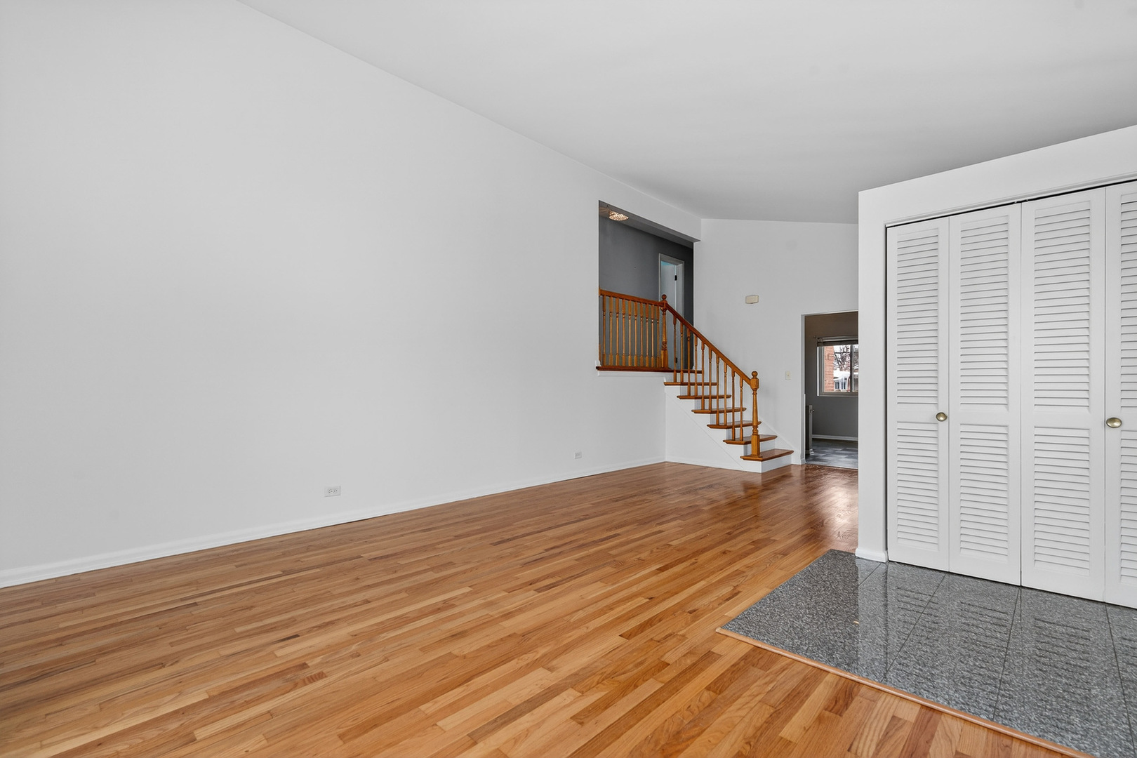 8516 West Normal Avenue Niles, IL 60714 - Photo 8 of 35 a view of an empty room with wooden floor and stairs