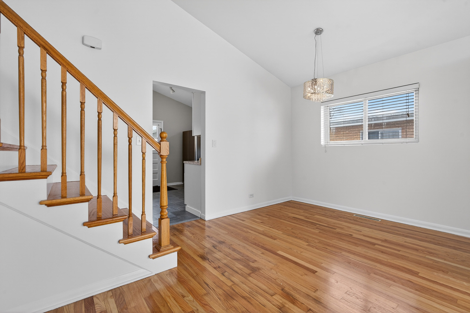 8516 West Normal Avenue Niles, IL 60714 - Photo 9 of 35 a view of an empty room with wooden floor and stairs
