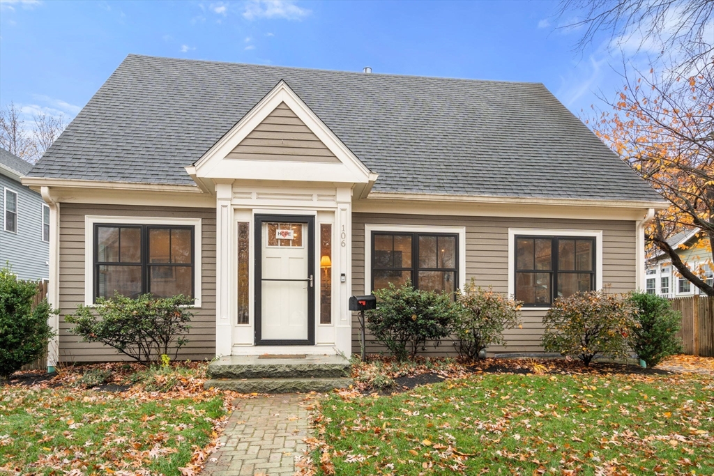 a view of house with yard and outdoor seating