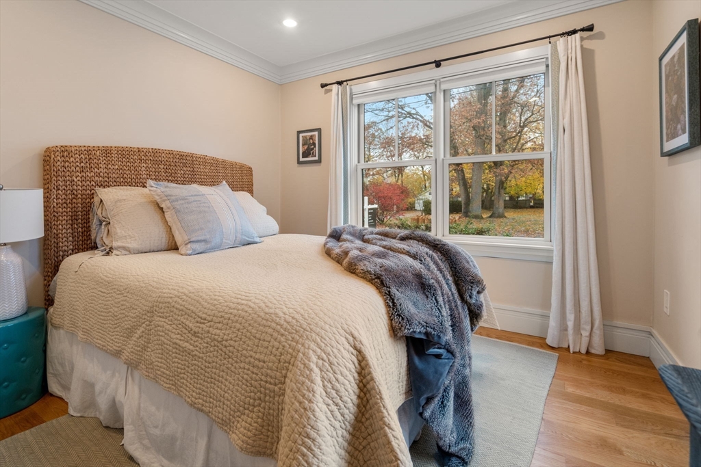 106 Jefferson Street Dedham, MA 02026 - Photo 18 of 42 a bed sitting in a bedroom next to a window