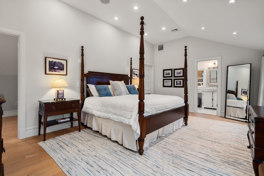 106 Jefferson Street Dedham, MA 02026 - Photo 24 of 42 a spacious bedroom with a bed and a table