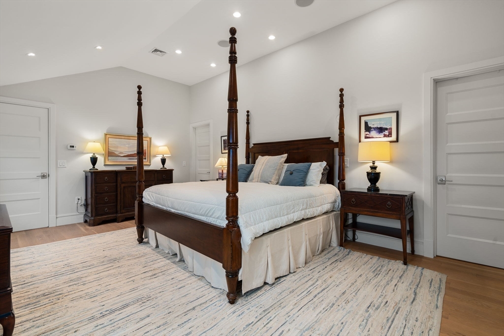 106 Jefferson Street Dedham, MA 02026 - Photo 25 of 42 a bedroom with a bed and a chandelier