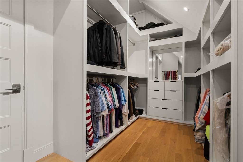 106 Jefferson Street Dedham, MA 02026 - Photo 28 of 42 a view of walk in closet with clothes and shoes
