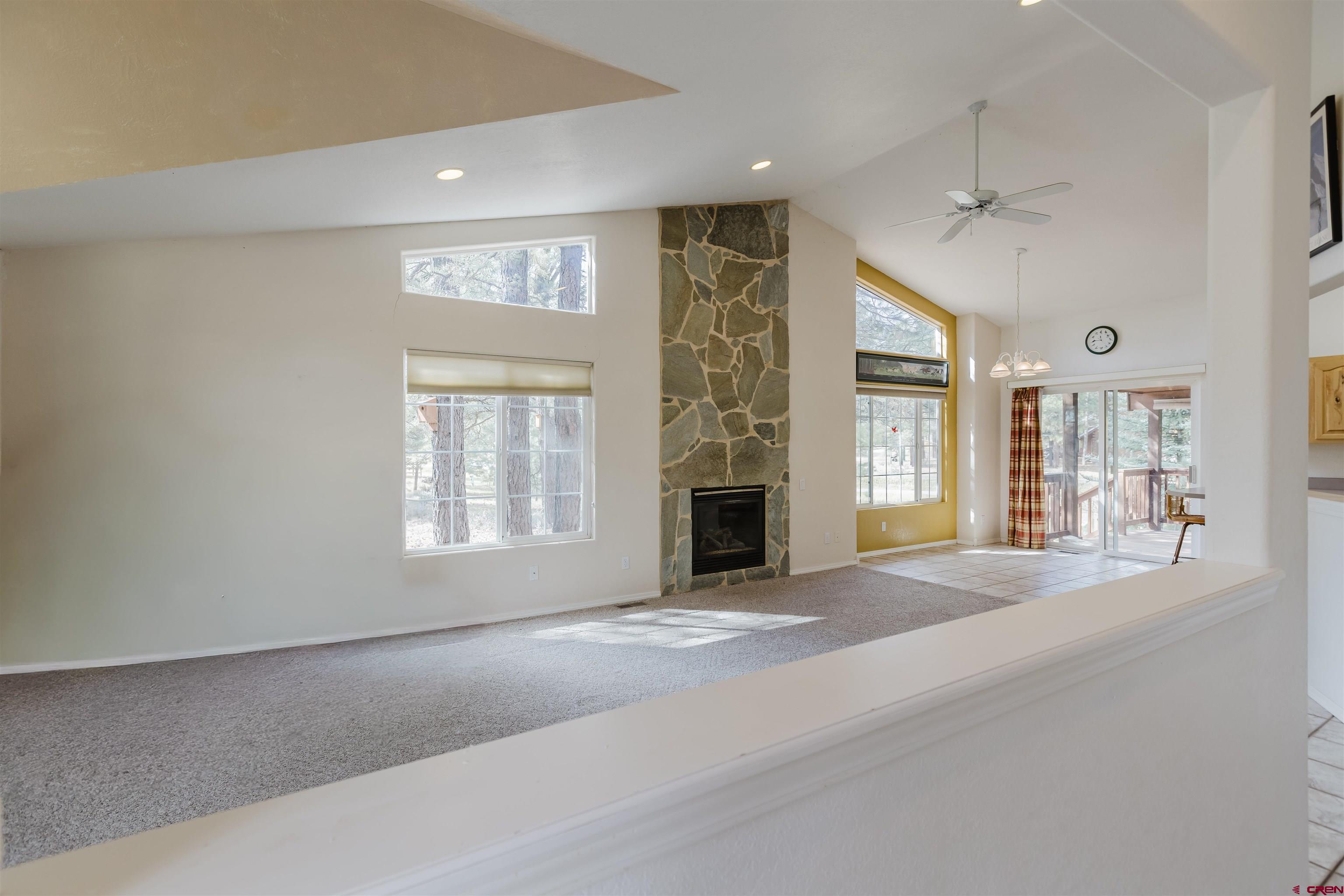 285 Beaver Circle Pagosa Springs, CO 81147 - Photo 15 of 42 a view of an empty room with a fireplace and a window