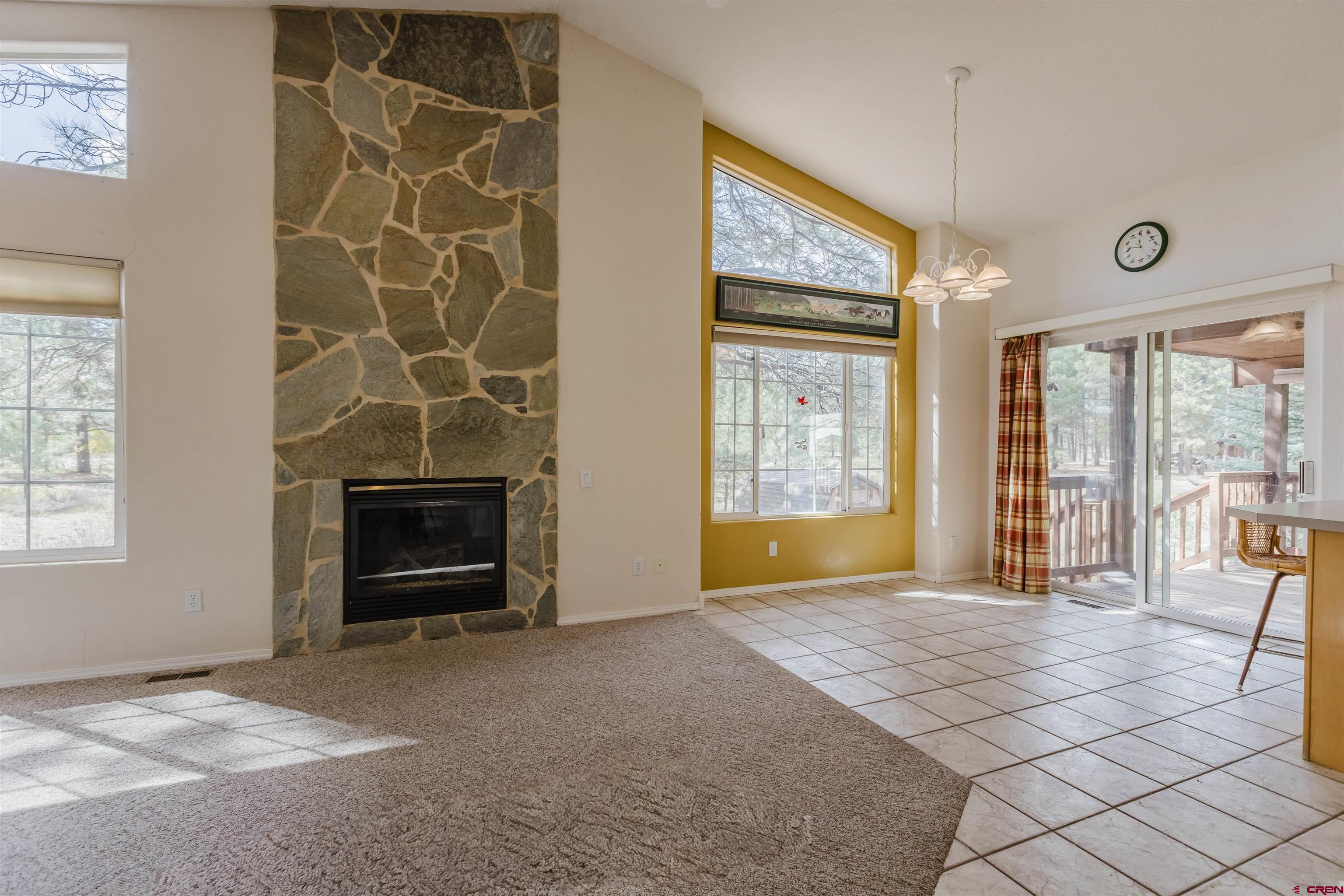 285 Beaver Circle Pagosa Springs, CO 81147 - Photo 16 of 42 a view of an empty room with a fireplace and a window