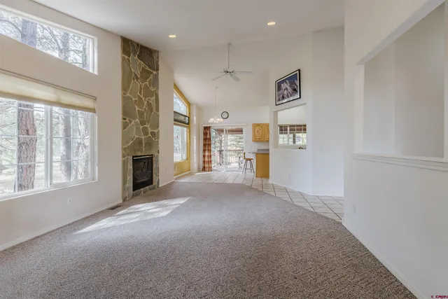 a view of a hallway with furniture and windows