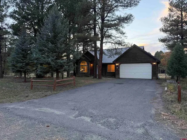 a view of a house with a yard and garage