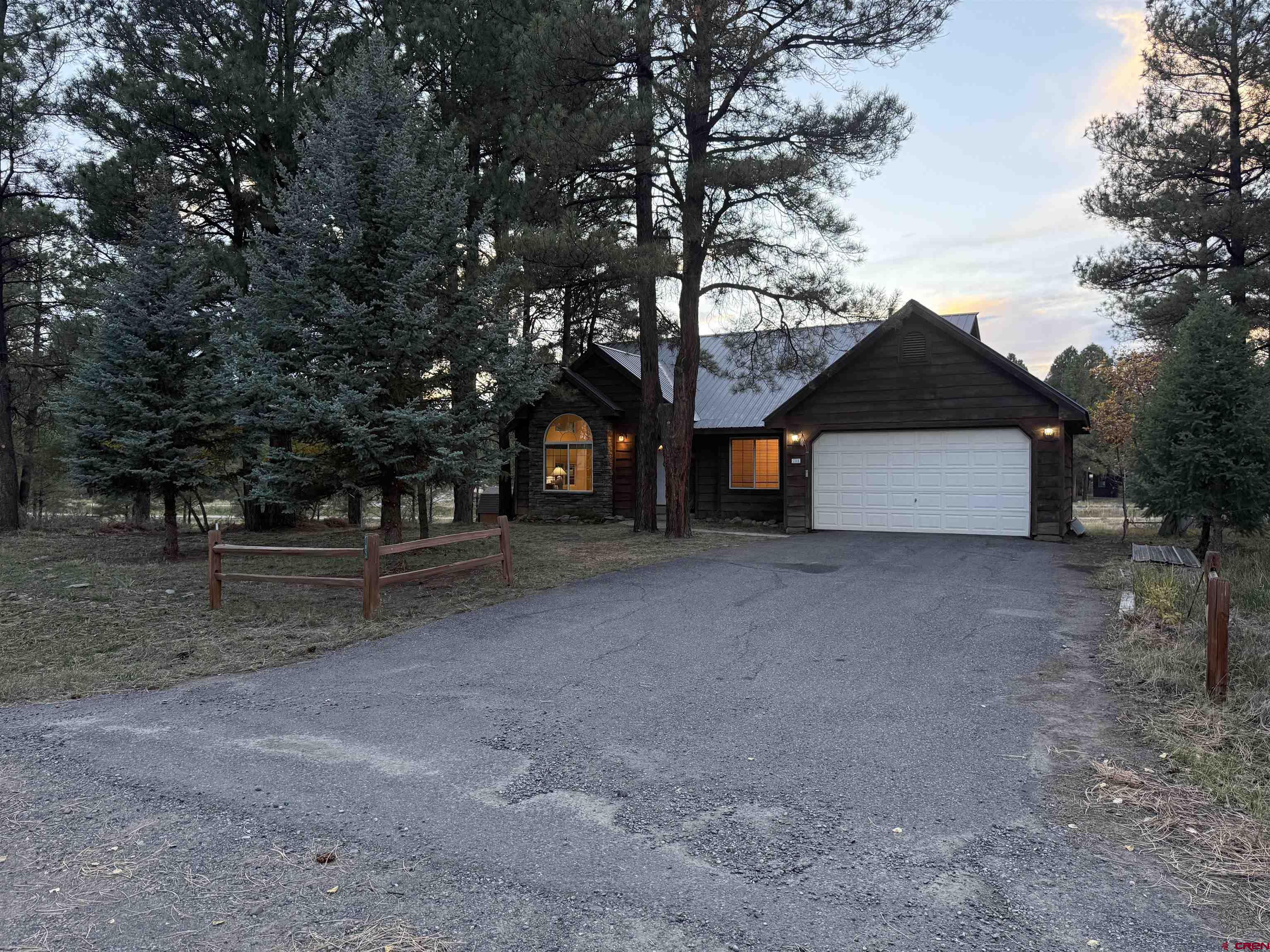 285 Beaver Circle Pagosa Springs, CO 81147 - Photo 2 of 42 a view of a house with a yard and garage