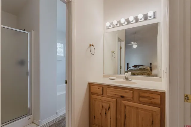 a bathroom with a sink vanity and mirror