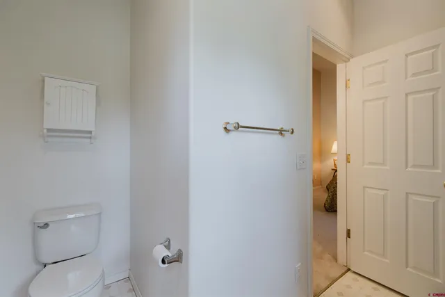 a white toilet sitting next to a shower curtain