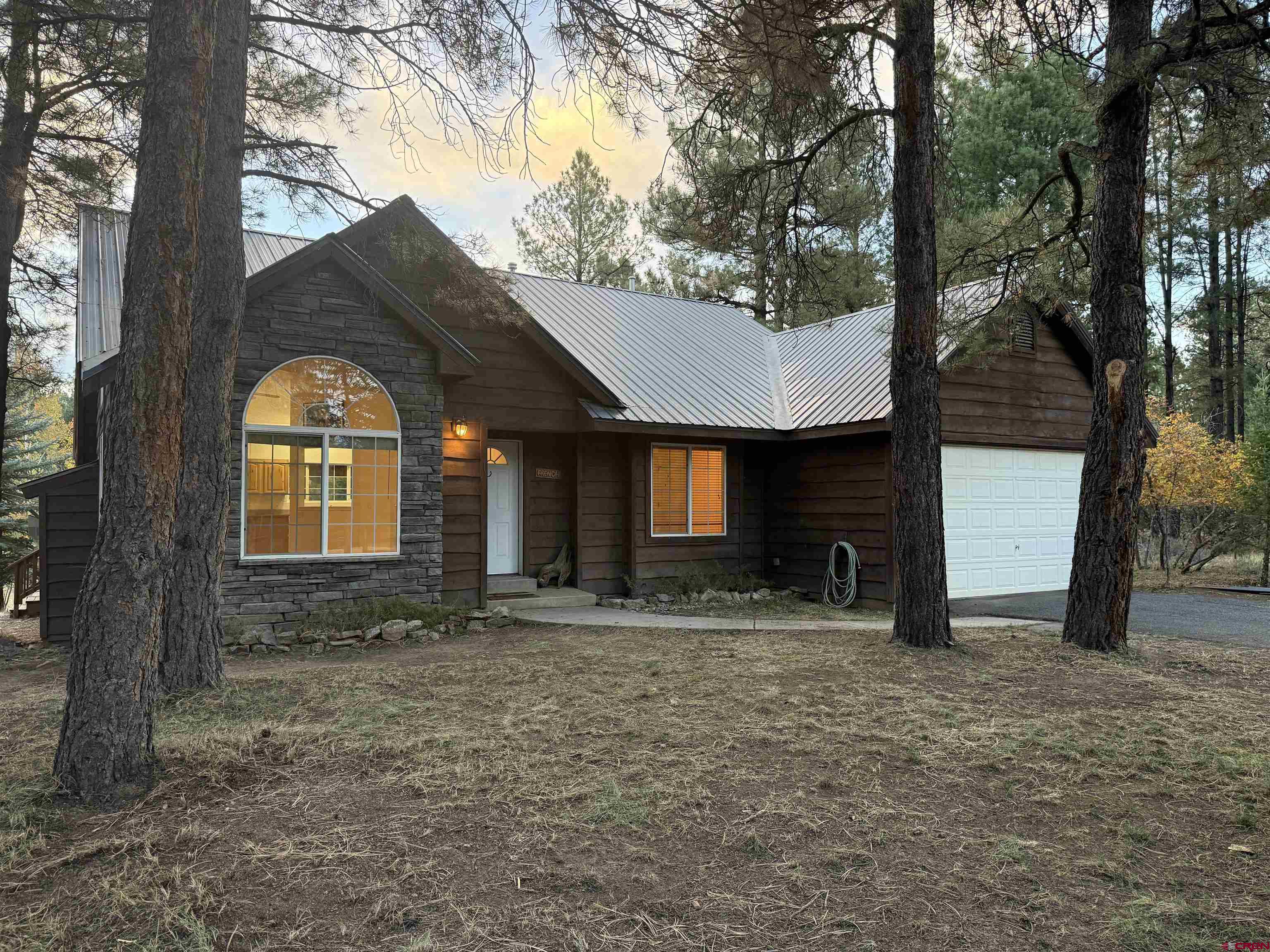 285 Beaver Circle Pagosa Springs, CO 81147 - Photo 3 of 42 a front view of a house with garden