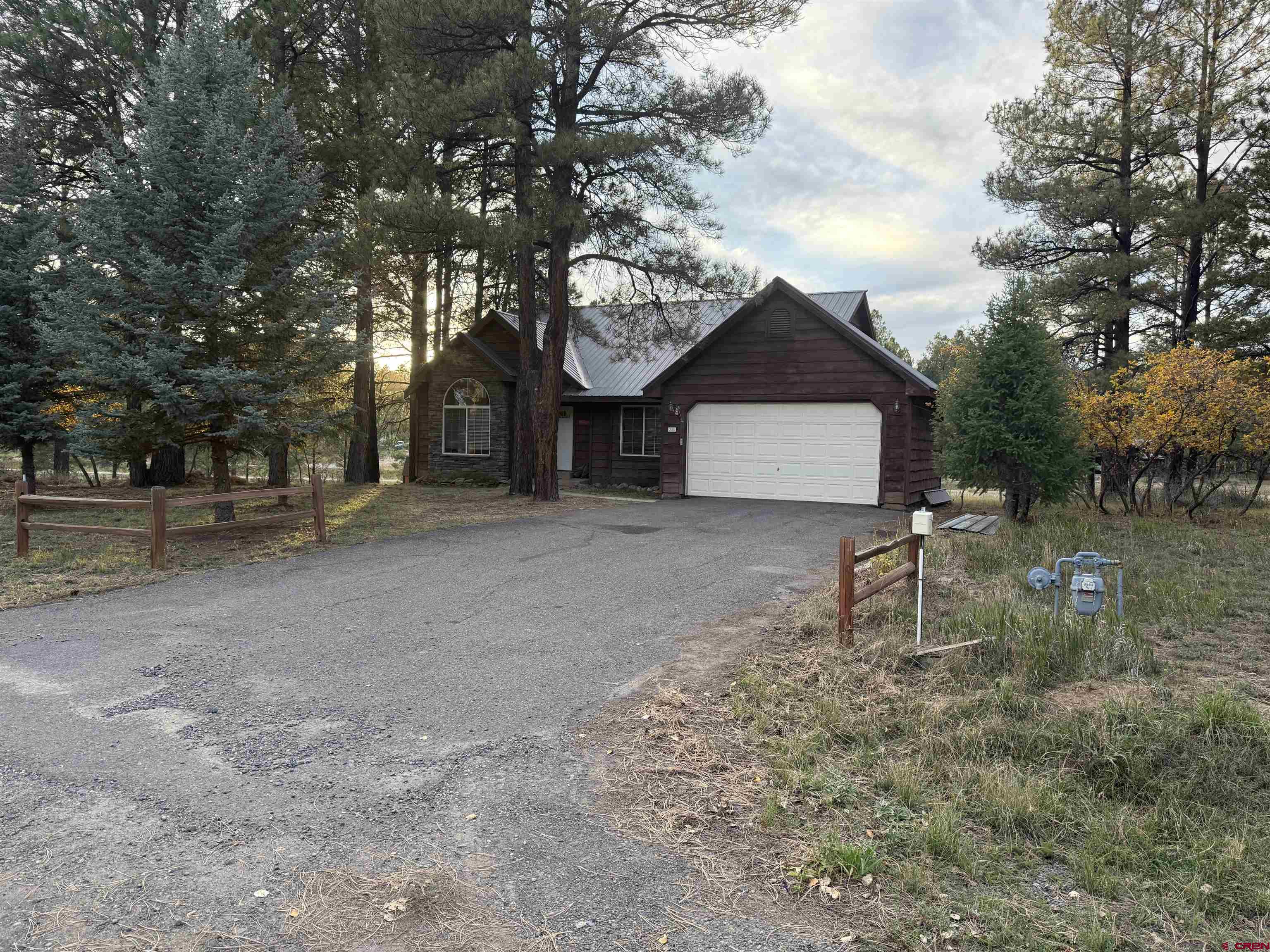 285 Beaver Circle Pagosa Springs, CO 81147 - Photo 4 of 42 a front view of a house with a yard
